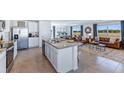Open concept kitchen with granite countertops and stainless steel appliances at 7123 Broad River Ave, Land O Lakes, FL 34638
