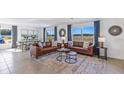 Spacious living room with leather couches and large windows at 7123 Broad River Ave, Land O Lakes, FL 34638
