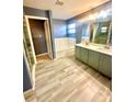 Spacious bathroom with double sinks, garden tub, and glass enclosed shower at 7423 Pulteney Dr, Zephyrhills, FL 33545