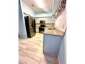 Cozy kitchen with stainless steel appliances, granite countertops, and a stylish tile backsplash at 7423 Pulteney Dr, Zephyrhills, FL 33545