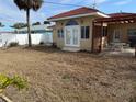 Backyard featuring white fence, patio area, and outdoor seating for relaxation and entertainment at 988 Bruce Ave, Clearwater Beach, FL 33767