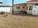 Expansive backyard with potential for landscaping and outdoor living, partially fenced at 988 Bruce Ave, Clearwater Beach, FL 33767