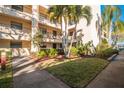 Building exterior showcasing landscaping and walkway at 11485 Oakhurst Rd # A203, Largo, FL 33774
