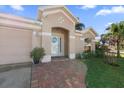 Attractive front entry with a brick walkway and lush landscaping at 12518 Midpointe Dr, Riverview, FL 33578