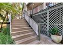 Steps leading to a raised porch with lattice detail at 1406 Butch Cassidy Trl, Wimauma, FL 33598