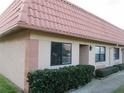 Light beige stucco building with a terracotta tile roof at 19029 Us Highway 19 N # 33A, Clearwater, FL 33764