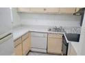 Small condo kitchen with light cabinets and appliances at 2625 State Road 590 # 622, Clearwater, FL 33759