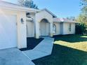 Inviting walkway leads to the entrance of this single-story home at 3465 Pericles Ave, North Port, FL 34289