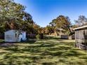 Spacious, fenced backyard with a shed and screened-in structure at 3741 New River Rd, Wesley Chapel, FL 33543