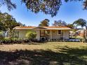 Inviting one-story home with a covered porch and a spacious front lawn at 3741 New River Rd, Wesley Chapel, FL 33543