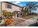 Landscaped front yard and paved walkway to the townhome's entrance at 3802 Brigadoon Cir, Clearwater, FL 33759