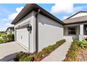 Side view of a single-story home showcasing the exterior wall, garage, and walkway at 6421 Mooring Line Cir, Apollo Beach, FL 33572