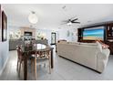 Open living and kitchen area with a large TV at 744 Jungle Queen Way, Longboat Key, FL 34228