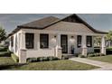 Exterior view of a modern white bungalow with black trim and landscaping at 1023 E 22Nd Ave, Tampa, FL 33605