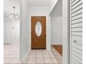 Welcoming entryway with an elegant wood and glass front door and tile flooring at 11902 Snapdragon Rd, Tampa, FL 33635