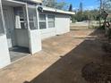 Concrete back patio with screened entrance and windows at 1386 19Th St, Sarasota, FL 34234