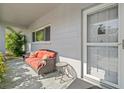 Inviting front porch with wicker seating, lush plants, and a screen door at 2294 Swedish Dr # 4, Clearwater, FL 33763