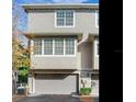A close-up view of the front of a townhouse with two garages at 2606 Espana Ct, Tampa, FL 33609