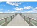Long wooden walkway extending into the water at 4775 Cove Cir # 904, St Petersburg, FL 33708