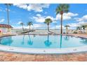Community pool with surrounding patio furniture at 4775 Cove Cir # 904, St Petersburg, FL 33708