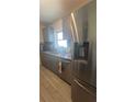 Modern kitchen featuring stainless steel appliances, granite countertops, and gray shaker cabinets at 6425 Rosewood Dr, Tampa, FL 33615