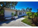 Inviting exterior showcasing a quaint, single-story home and tidy front yard landscaping at 9567 85Th St, Seminole, FL 33777