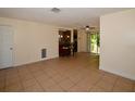 Open living area with tile flooring, seamlessly connecting to the kitchen and outdoor space at 9567 85Th St, Seminole, FL 33777