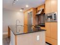 Sleek kitchen featuring stainless steel appliances, granite countertops, and wood cabinetry at 1120 E Kennedy Blvd # 927, Tampa, FL 33602
