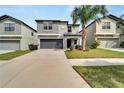 Two-story residence with a gray facade, attached garage, and concrete driveway at 12728 Lemon Pepper Dr, Riverview, FL 33578