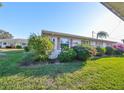 Neat and clean exterior showcasing a manicured lawn at 1901 Canterbury Ln # 19, Sun City Center, FL 33573