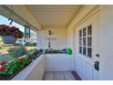 Inviting front porch with potted plants and wind chimes at 1901 Canterbury Ln # 19, Sun City Center, FL 33573