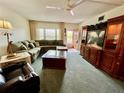 Cozy living room showcasing a large sectional sofa, wood furnishings, and bright natural light at 2403 Finlandia Ln # 57, Clearwater, FL 33763