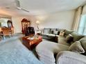 Comfortable living room featuring a large sectional sofa and classic wood furniture at 2403 Finlandia Ln # 57, Clearwater, FL 33763