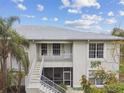 Charming condo with second floor balcony, lush landscaping, and classic architectural details at 2632 River Preserve Ct, Bradenton, FL 34208