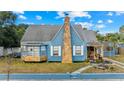 Charming blue home with stone accents, landscaping, and a welcoming front entrance at 306 E Paris St, Tampa, FL 33604