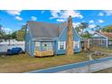 Blue home with stone accents, front yard landscaping, and a bay window at 306 E Paris St, Tampa, FL 33604