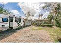 Front exterior view of a home with an RV parked on a paved driveway and landscaping at 307 10Th Ave, Indian Rocks Beach, FL 33785