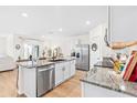 Bright kitchen features granite counters, stainless steel appliances, and hardwood floors at 33510 Elm Hill Branch, Wesley Chapel, FL 33545