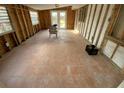 Empty living room with tiled floor, exposed framing, windows, and door at 415 86Th Ave, St Pete Beach, FL 33706