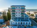Modern condominium building featuring multiple balconies and a rooftop pool and spa at 15 Avalon St # 704, Clearwater Beach, FL 33767