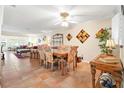 Dining area with tile floors, a wooden table, and access to the living room at 19029 Us Highway 19 # 25D, Clearwater, FL 33764