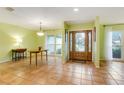 Welcoming foyer with tile floors, entryway table, and stylish chandelier at 4618 Player Ct, Tampa, FL 33624