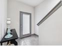 Modern entryway with gray tile floor, gray door, and console table at 4810 W Mcelroy Ave # 2, Tampa, FL 33611