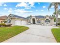 Two-story house with a large driveway and lush landscaping at 636 Citrus Wood Ln, Valrico, FL 33594