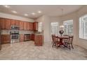 Well-lit eat-in kitchen featuring stainless steel appliances and wood cabinets at 8620 Brookway Cir, Tampa, FL 33635