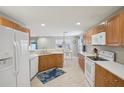 Spacious kitchen with wood cabinets, white appliances, and tile flooring at 11908 Whisper Creek Dr, Riverview, FL 33569