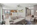 Open living room and kitchen with modern, neutral decor and tile floors at 11908 Whisper Creek Dr, Riverview, FL 33569