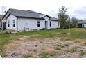 View of the backyard of a house with some dry grass at 16851 Forge Surf St, Land O Lakes, FL 34638
