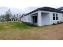 Backyard with a covered patio and green lawn at 16851 Forge Surf St, Land O Lakes, FL 34638