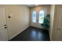 Bright and spacious foyer with dark tile floors and a decorative model sailboat at 3020 Sheppards Crook Ct, Holiday, FL 34691